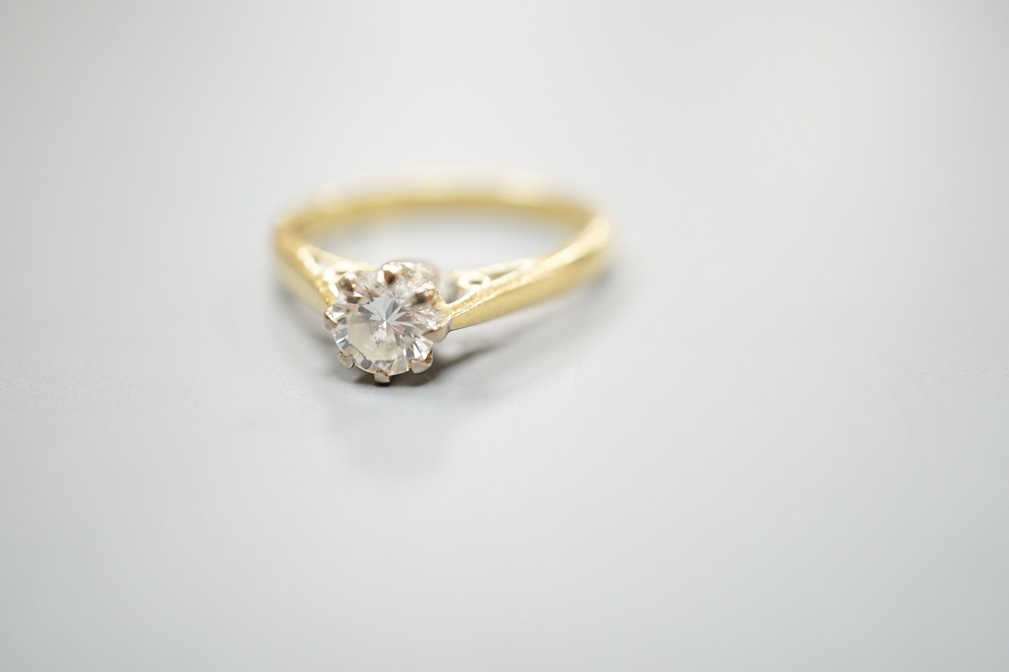 A modern 18ct gold and solitaire diamond ring, size N, gross weight 3.5 grams